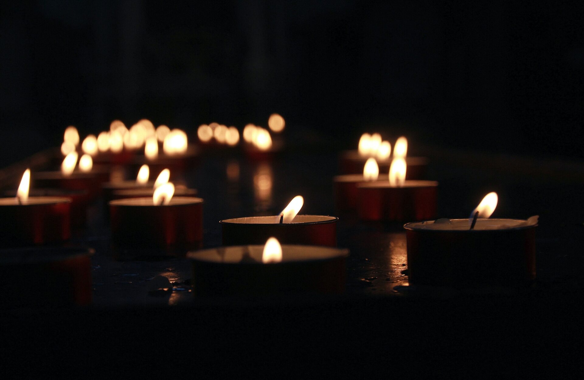 Candles lit in a room, displayed for a custom burial service